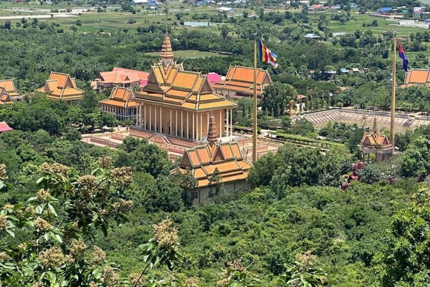 A temple complex with traditional architecture, surrounded by lush greenery. 1
