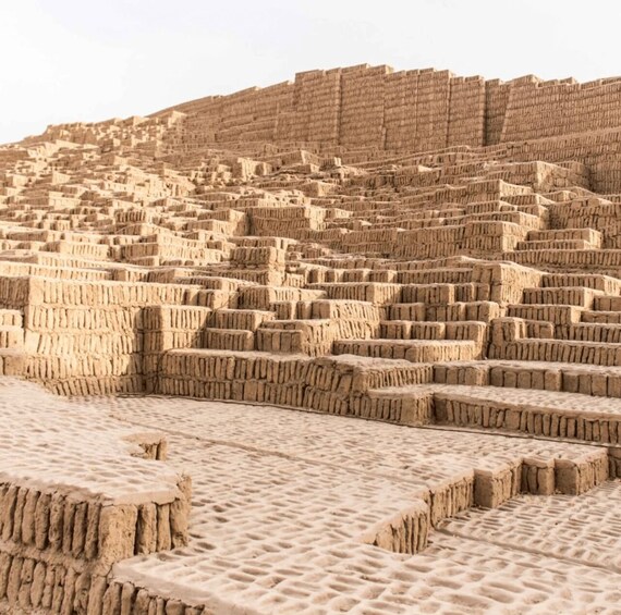 A vast, terraced landscape with multiple levels of earthen structures. 2