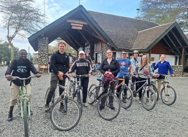 A group of people with bicycles in front of a building labeled 'HELL'S GATE N PARK'. 1