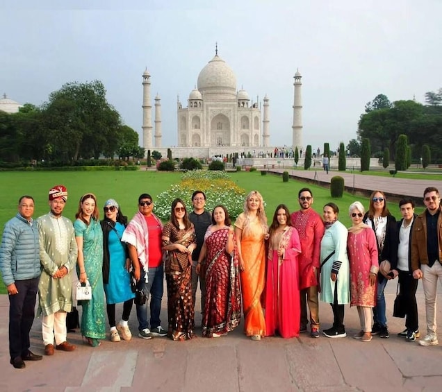 A group of people standing in front of the Taj Mahal. 1