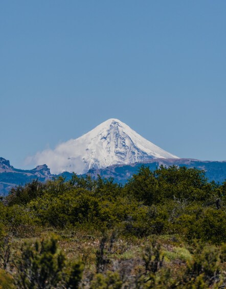 A snow-capped mountain with a clear sky. 5