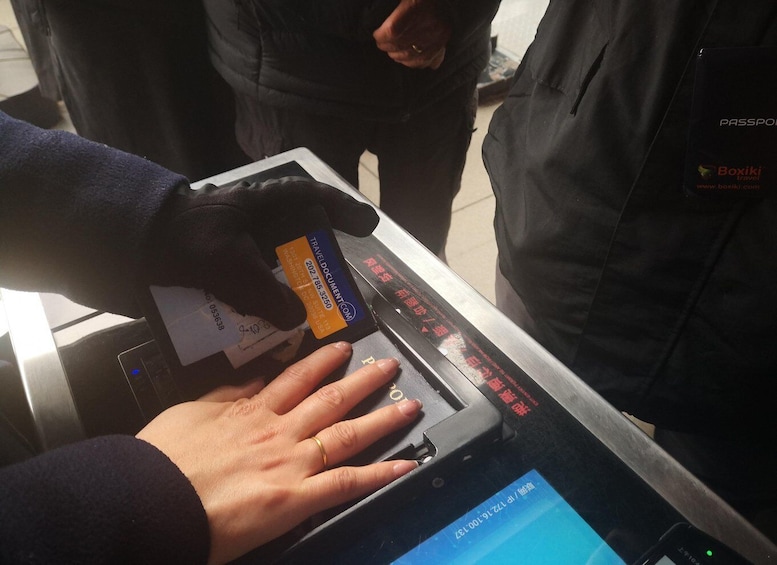 A person using a passport control machine at an airport. 5