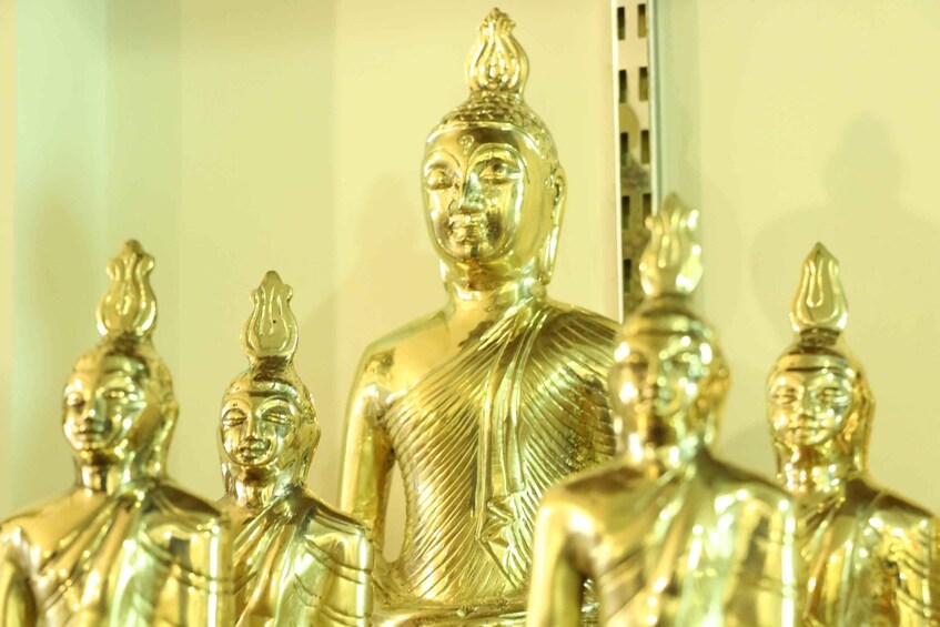 A collection of golden Buddha statues. 5
