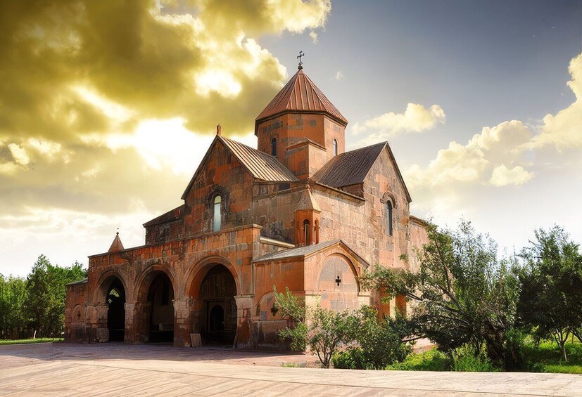 A historic church with a red-tiled roof, arched windows, and a bell tower. 2