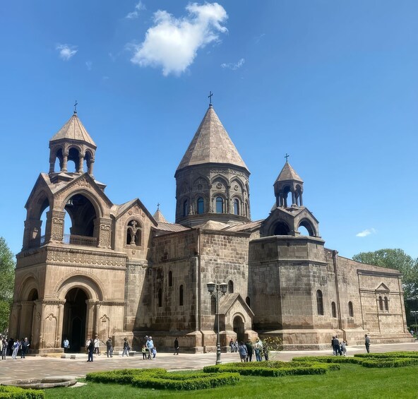 A historic church with three towers and a large central dome. 4