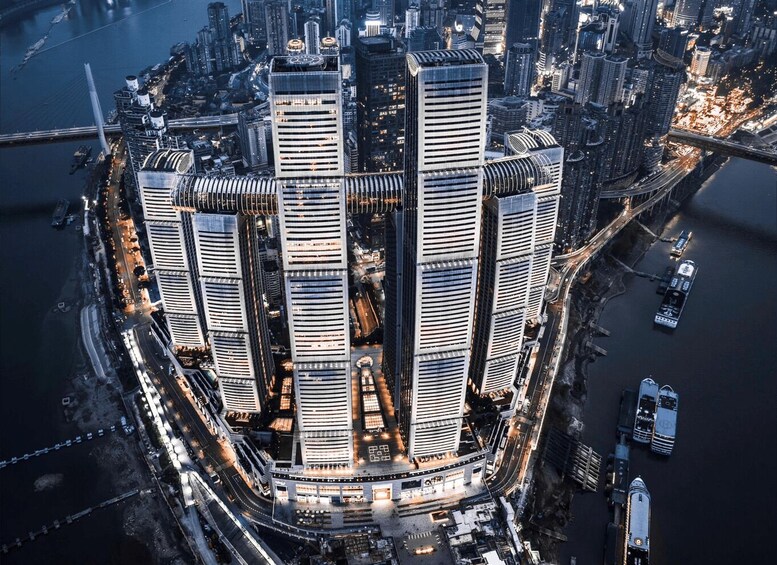 A cluster of modern skyscrapers with a river and bridge in the background. 3