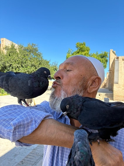 A person holding pigeons. 3