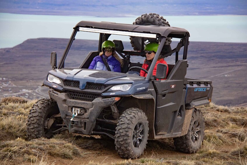 A UFORCE 5000 ATV on a grassy terrain with a mountainous backdrop. 3