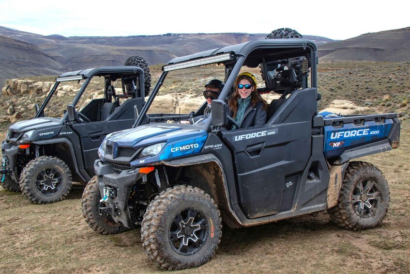 Three UFORCE 1000 off-road vehicles parked in a desert landscape. 4