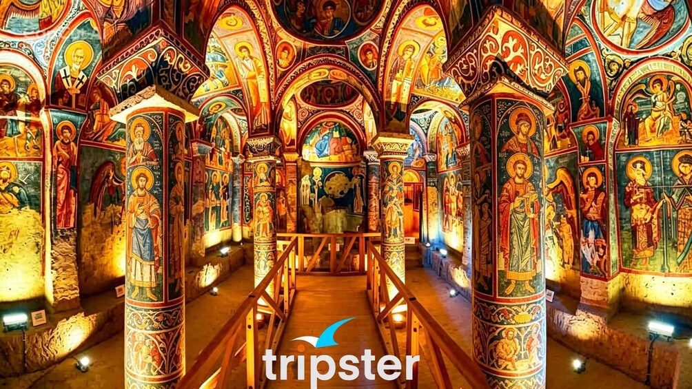 An ornate church interior with detailed mosaics and columns. 1