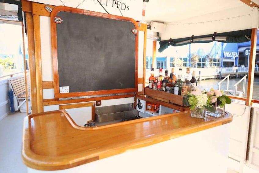 A bar area with a chalkboard, wooden counter, and various bottles. 4