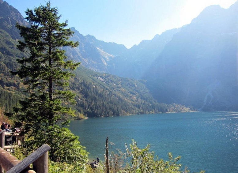 A mountain lake surrounded by forested hills. 1