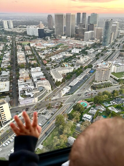 A cityscape with tall buildings, roads, and a person with outstretched arms. 2
