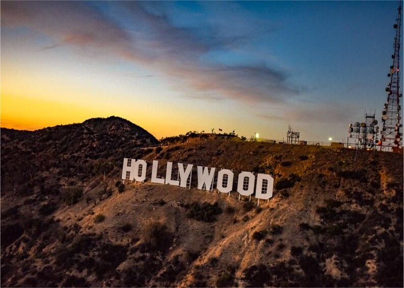 A desert landscape with the text 'HOLLYWOOD' prominently displayed on a hill. 3