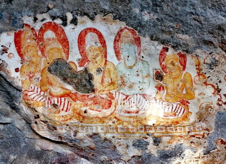 An ancient fresco with figures in traditional attire, set against a stone wall. 5