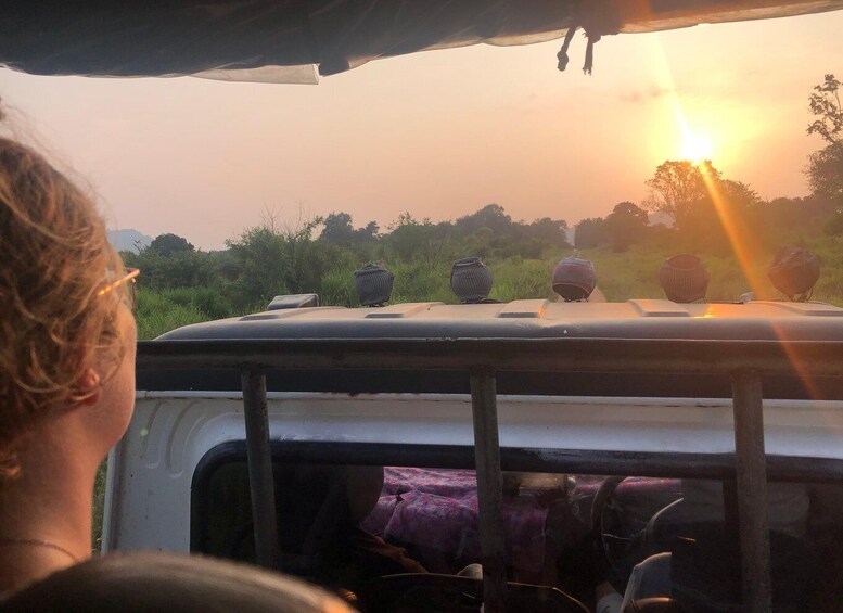 A vehicle's roof with decorative items and a sunset in the background. 1