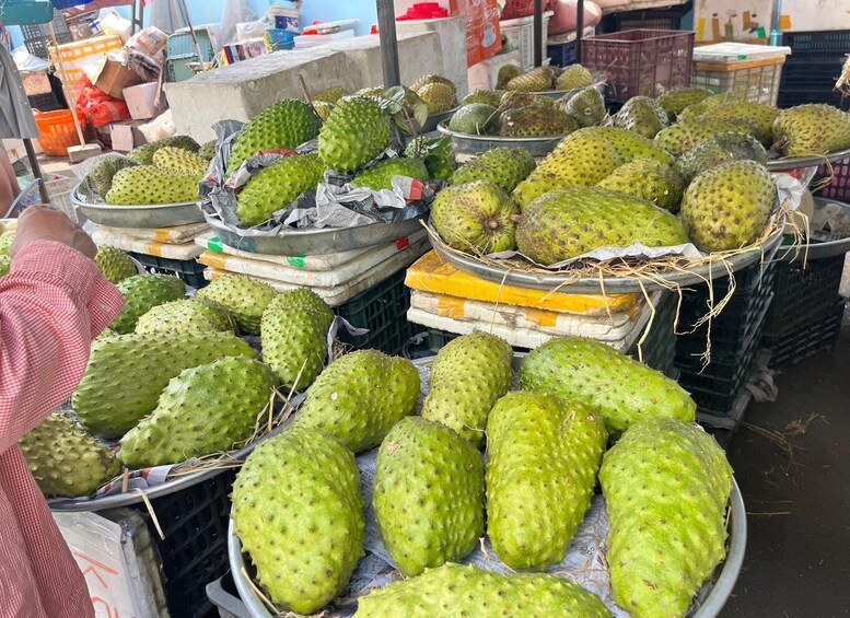 Durians displayed in baskets at a market. 2