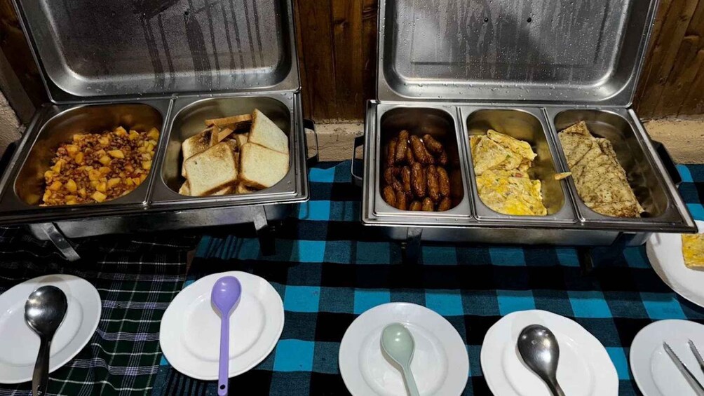 A buffet with various food items including toast, sausages, and omelets. 4