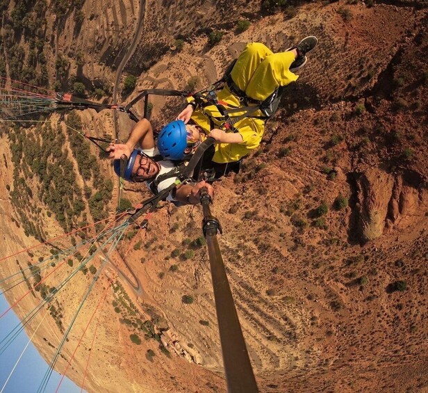 A person bungee jumping from a high cliff with a harness and helmet. 4