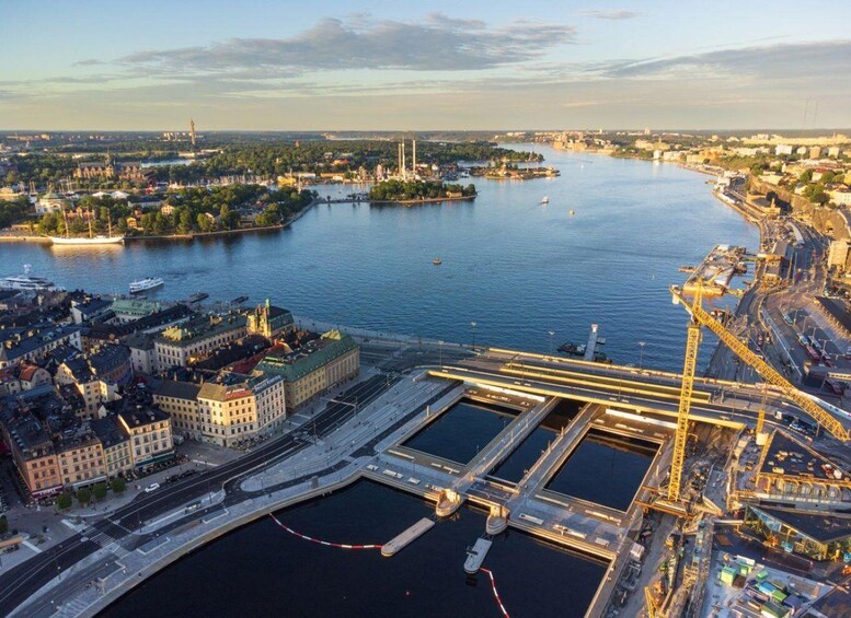 A river with a bridge, a ship, and a port area with cranes. 1