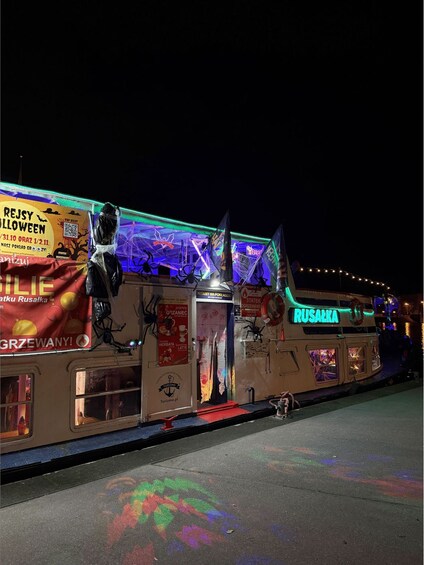 A decorated bus with Halloween themes, including spider decorations and a spooky atmosphere. 3