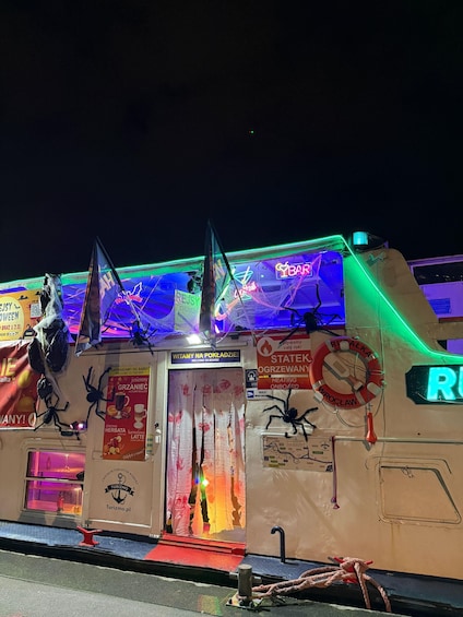 A building with Halloween decorations, including spider webs and a life preserver. 2