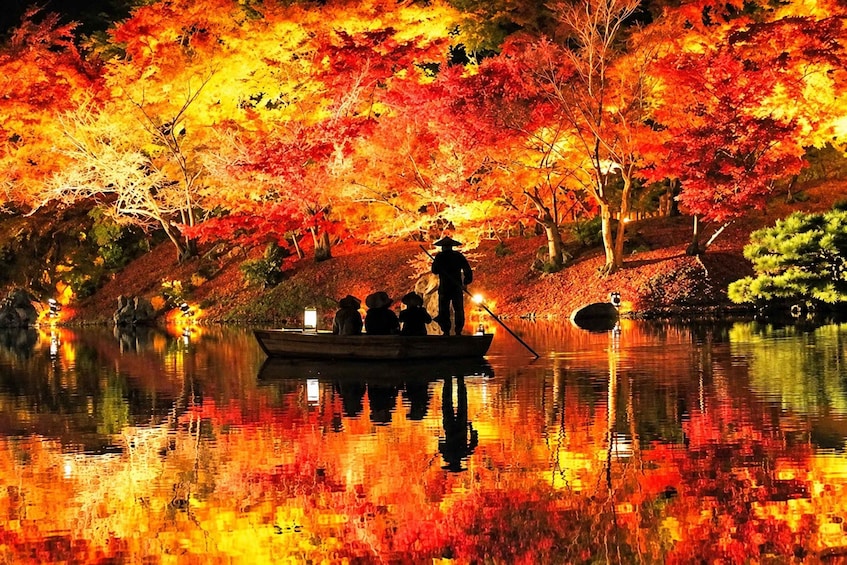 A serene autumn scene with a boat carrying people and a person in traditional attire on a calm lake surrounded by vibrant fall foliage. 1