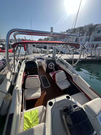 A boat's deck with seating and a steering wheel. 4