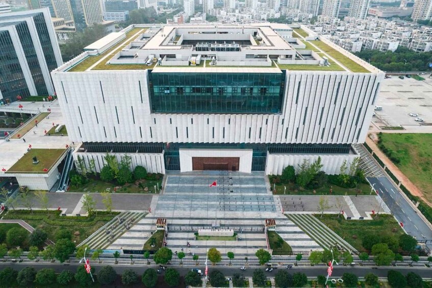 A modern building with a large glass facade and a central entrance. 4