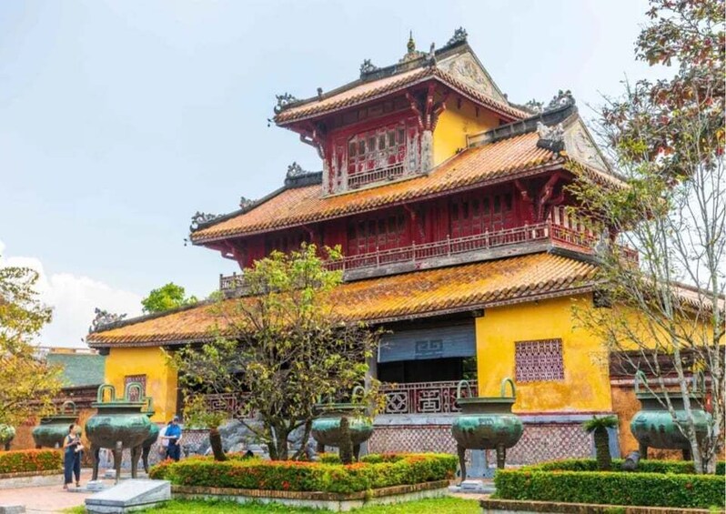 A traditional building with ornate architecture, including a tiled roof and decorative elements. 2