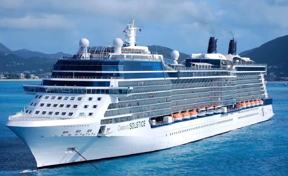A large cruise ship named Celebrity Solstice sailing in the ocean. 5