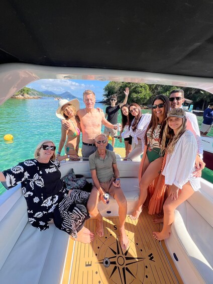A group of people on a boat with a compass on the deck. 1