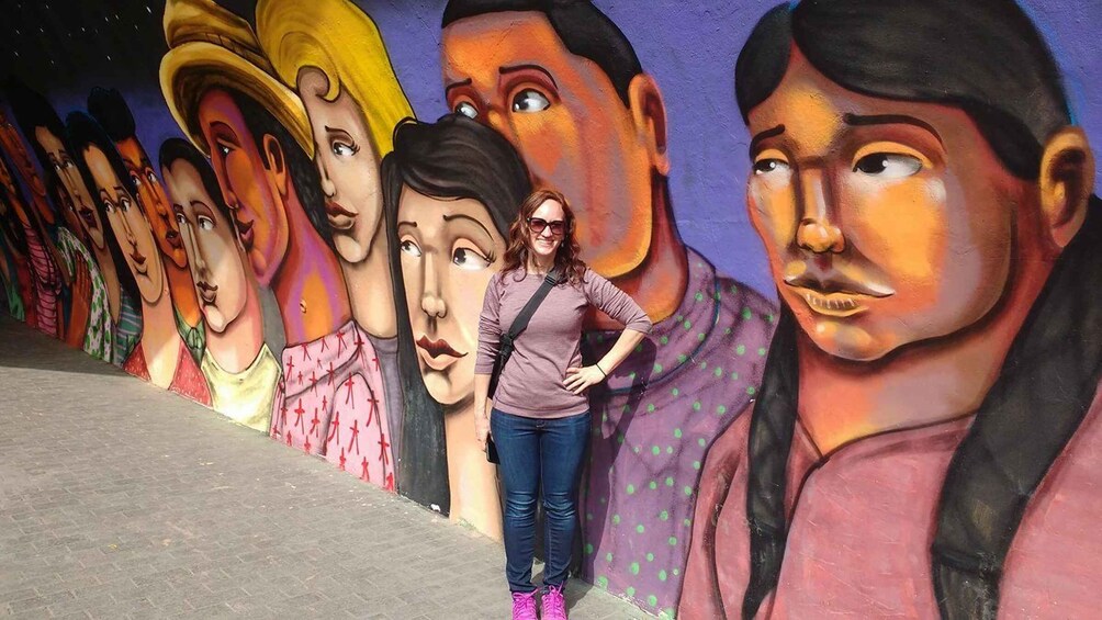 A mural of various faces on a wall. 2