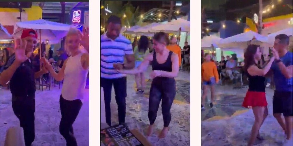 People dancing under umbrellas at an outdoor event. 1