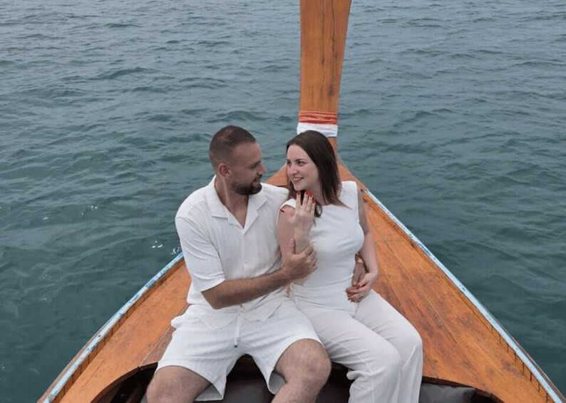 A couple in a wooden boat on calm water. 2