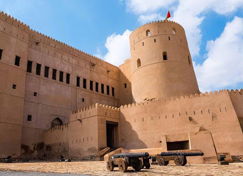 A historic fort with a round tower and cannons. 2
