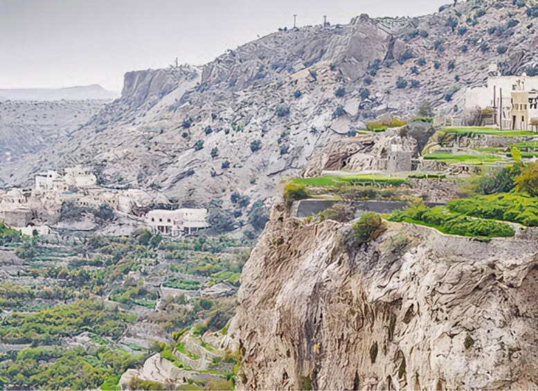 A rugged mountainous landscape with terraced fields and traditional buildings. 3