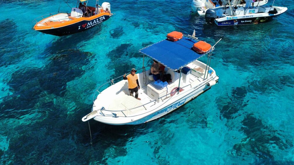 A clear blue sea with boats. 5