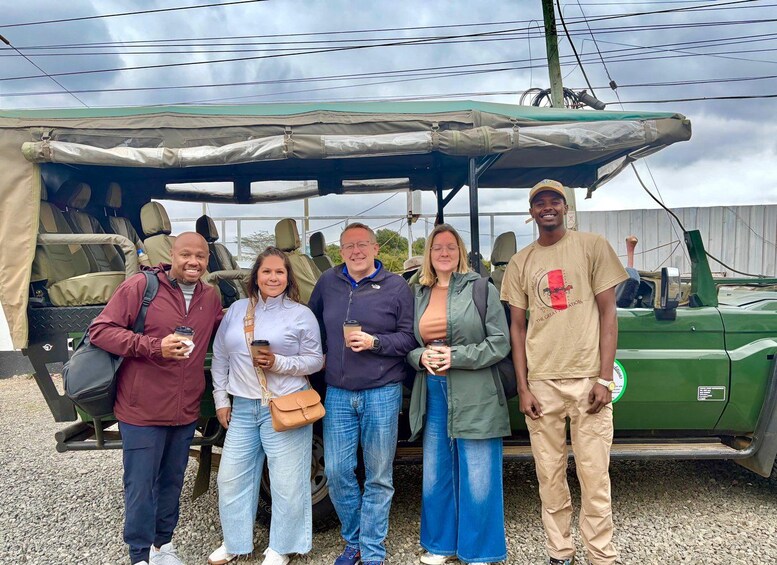 A group of people standing in front of a green vehicle with a canopy. 5
