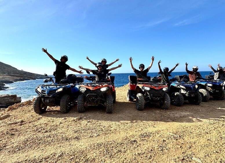 A group of people on ATVs by the sea. 1
