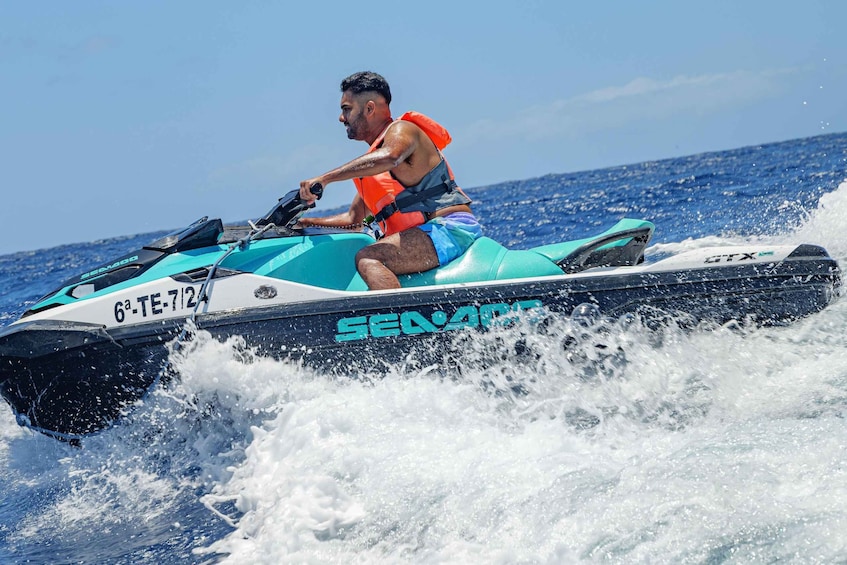 A person riding a jet ski on the water. 3