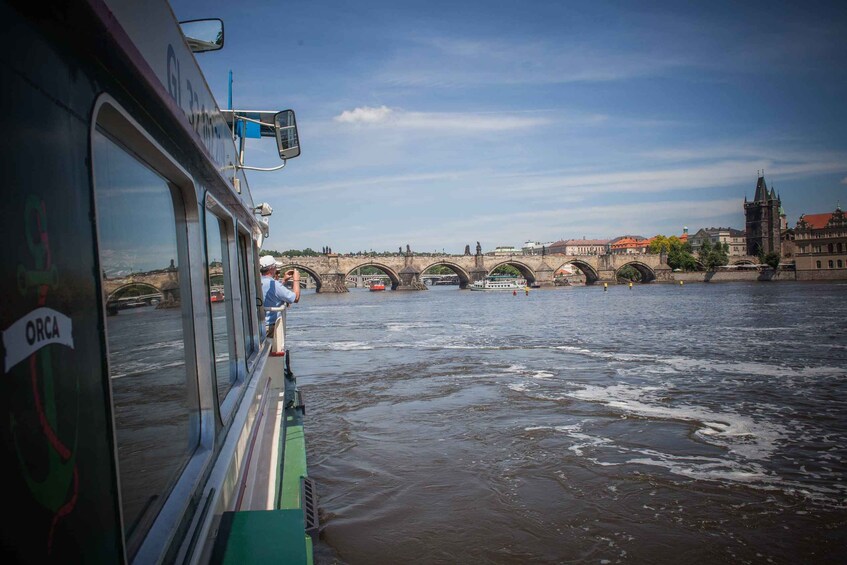 A river with a bridge in the background and a boat in the foreground. 4