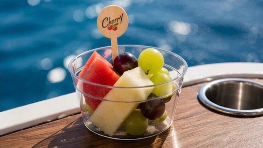 A bowl of fruit with a cherry label on a boat. 3