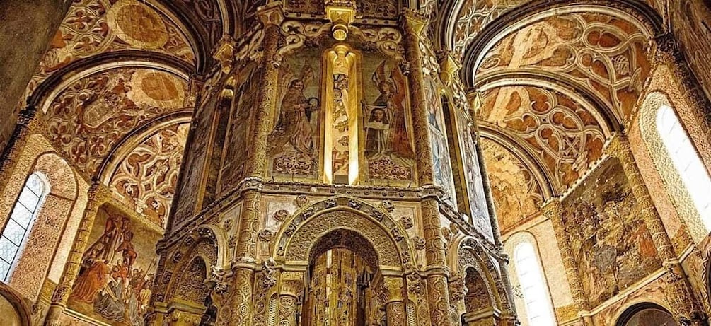 An ornate interior with intricate golden designs and arches. 3