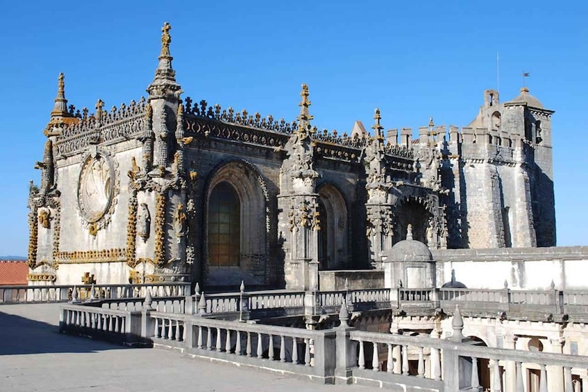 A historic building with ornate architecture, featuring a large arched doorway and intricate stone carvings. 5
