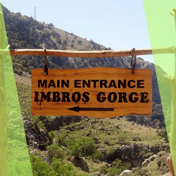 A wooden sign with the text "MAIN ENTRANCE IMBROS GORGE" and an arrow pointing left. 5