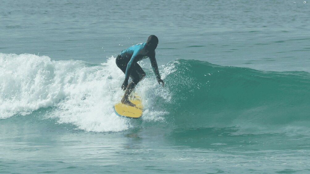 A person surfing a wave in the ocean. 5