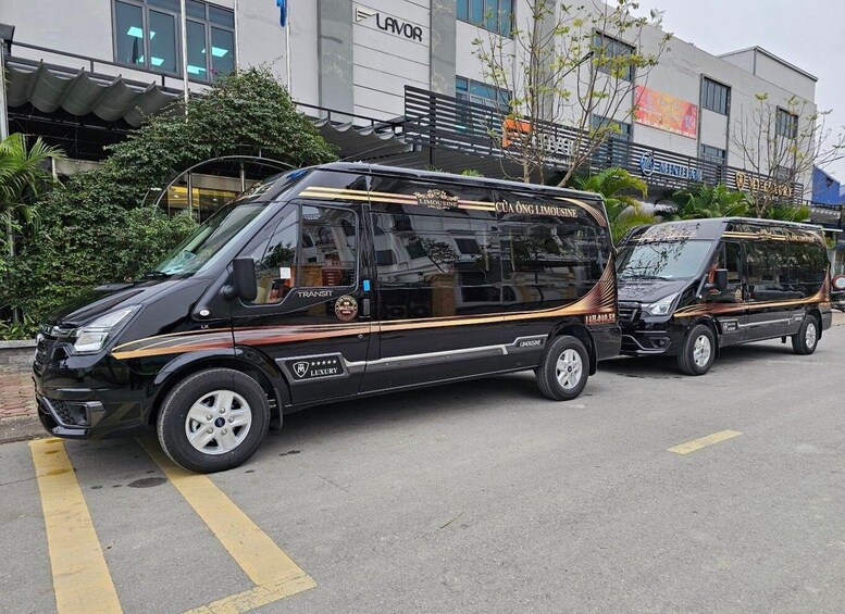 A black luxury transit van with gold accents parked on a street. 1