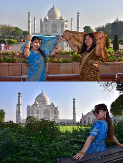 Two women in traditional attire posing in front of the Taj Mahal. 5