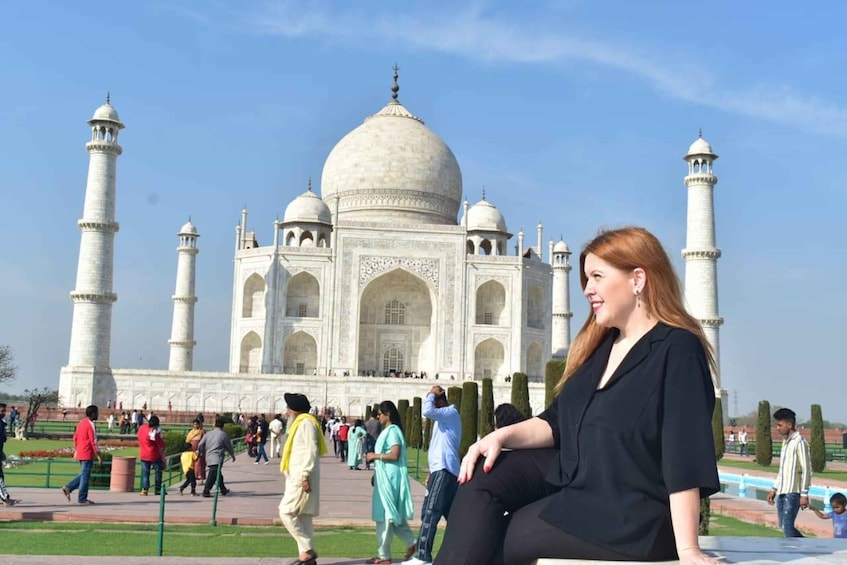 The Taj Mahal with visitors around it. 3